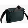 Deep Ocean Venture Travel Crossbody by Bellroy shoulder bag with a phone on a white background