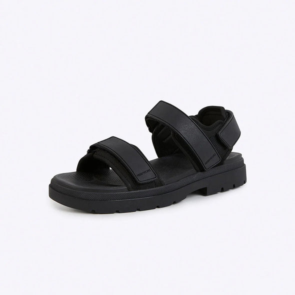 Black sandal with velcro straps on a white background