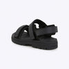 Black sandal with multiple straps on a white background
