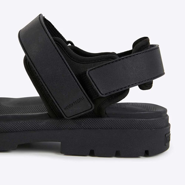 Black sandal with strap design on a white background