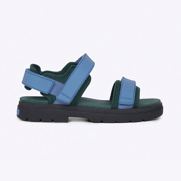 Blue and green sandal with black sole on a white background